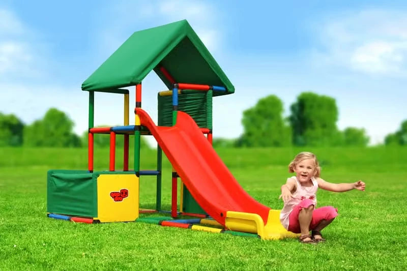 Child seated beside a tall QUADRO tower with straight modular red slide