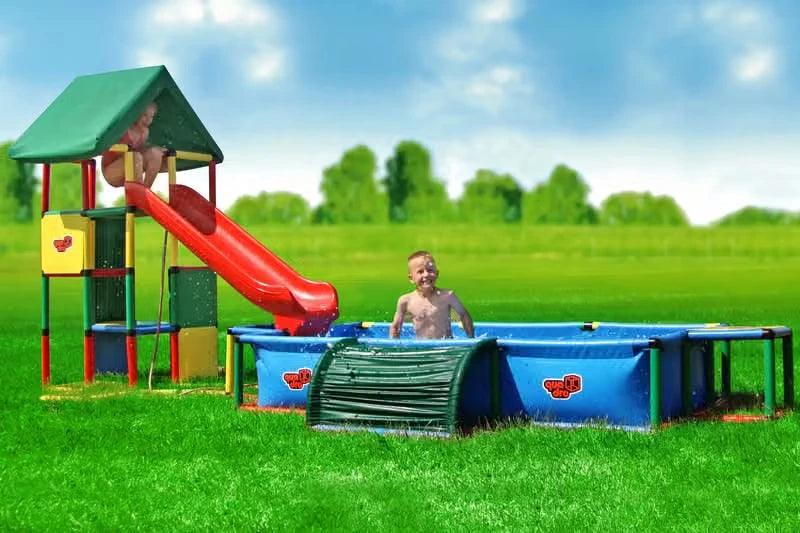 Wide view of a covered QUADRO tower, red slide and extended XXL pool